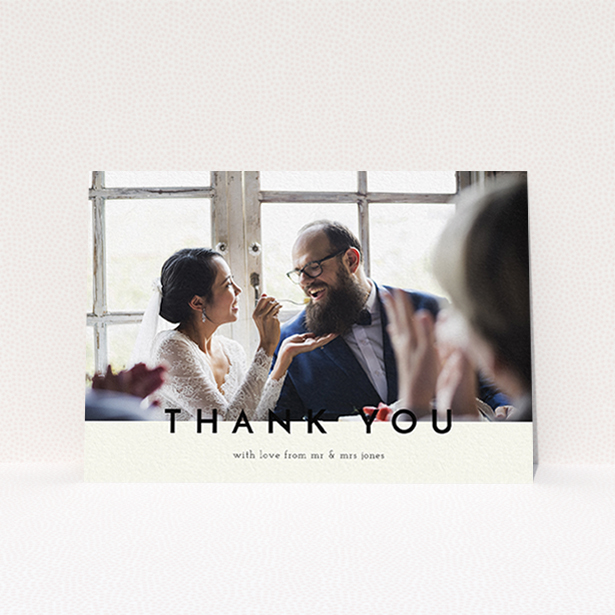 A wedding thank you card named "Split thank you ". It is an A6 card in a landscape orientation. It is a photographic wedding thank you card with room for 1 photo. "Split thank you " is available as a flat card, with mainly cream colouring.