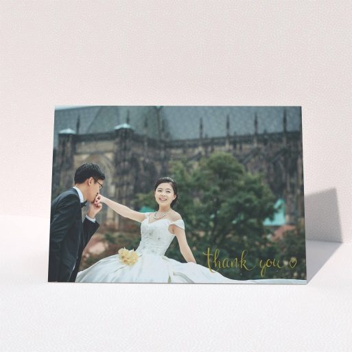 A wedding thank you card design titled "Thank you with a heart". It is an A5 card in a landscape orientation. It is a photographic wedding thank you card with room for 1 photo. "Thank you with a heart" is available as a folded card, with mainly gold colouring.