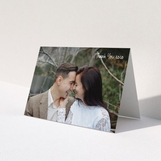 A wedding thank you card template titled 'Thank You XOXO'. It is an A5 card in a landscape orientation. It is a photographic wedding thank you card with room for 1 photo. 'Thank You XOXO' is available as a folded card, with mainly white colouring.