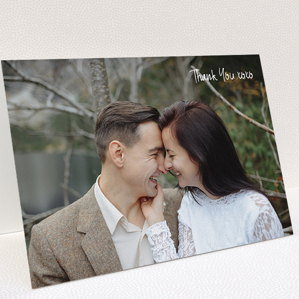 A wedding thank you card template titled "Thank You XOXO". It is an A5 card in a landscape orientation. It is a photographic wedding thank you card with room for 1 photo. "Thank You XOXO" is available as a folded card, with mainly white colouring.
