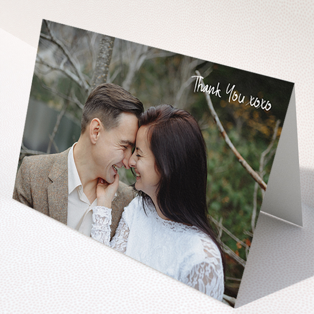 A wedding thank you card template titled "Thank You XOXO". It is an A5 card in a landscape orientation. It is a photographic wedding thank you card with room for 1 photo. "Thank You XOXO" is available as a folded card, with mainly white colouring.