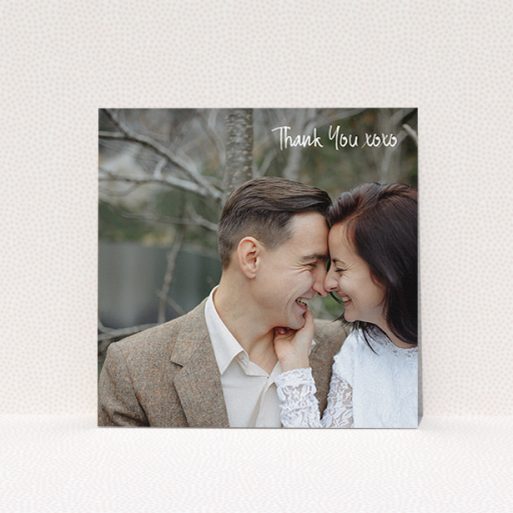A wedding thank you card design called "Thank You XOXO". It is a square (148mm x 148mm) card in a square orientation. It is a photographic wedding thank you card with room for 1 photo. "Thank You XOXO" is available as a flat card, with mainly white colouring.