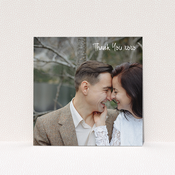 A wedding thank you card design called "Thank You XOXO". It is a square (148mm x 148mm) card in a square orientation. It is a photographic wedding thank you card with room for 1 photo. "Thank You XOXO" is available as a flat card, with mainly white colouring.