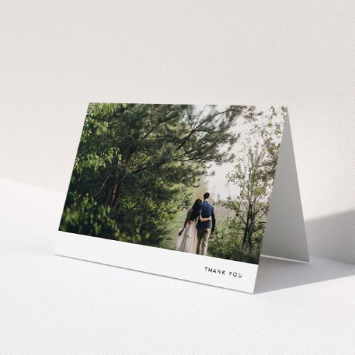 A wedding thank you card design called 'Thankful with Simplicity'. It is an A5 card in a landscape orientation. It is a photographic wedding thank you card with room for 1 photo. 'Thankful with Simplicity' is available as a folded card, with mainly white colouring.