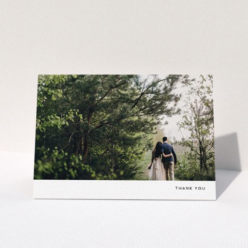 A wedding thank you card design titled "Thankful with Simplicity". It is an A6 card in a landscape orientation. It is a photographic wedding thank you card with room for 1 photo. "Thankful with Simplicity" is available as a folded card, with mainly white colouring.