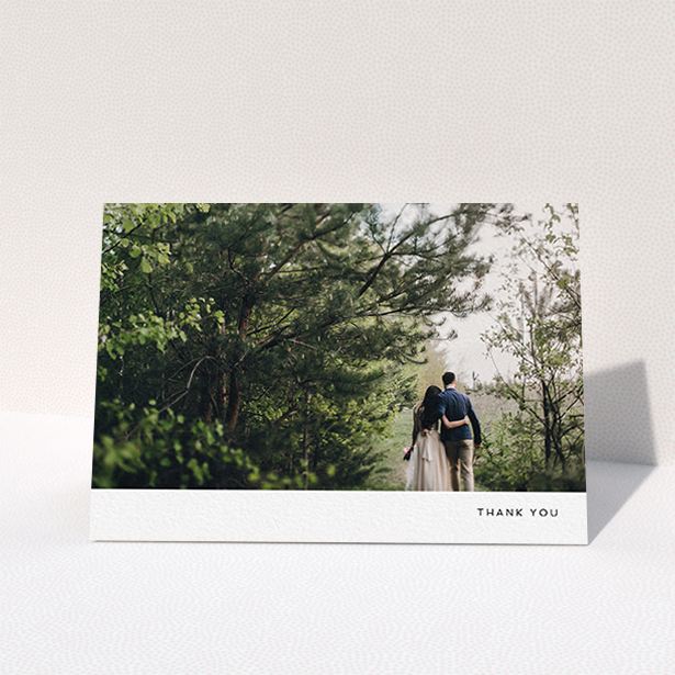 A wedding thank you card design titled "Thankful with Simplicity". It is an A6 card in a landscape orientation. It is a photographic wedding thank you card with room for 1 photo. "Thankful with Simplicity" is available as a folded card, with mainly white colouring.