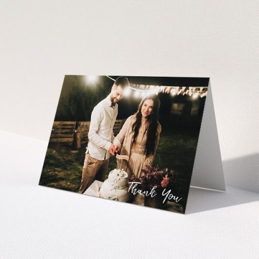 A wedding thank you card named 'Thanks From The Corner'. It is an A5 card in a landscape orientation. It is a photographic wedding thank you card with room for 1 photo. 'Thanks From The Corner' is available as a folded card, with mainly white colouring.