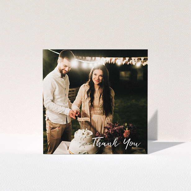 A wedding thank you card named "Thanks From The Corner". It is a square (148mm x 148mm) card in a square orientation. It is a photographic wedding thank you card with room for 1 photo. "Thanks From The Corner" is available as a folded card, with mainly white colouring.