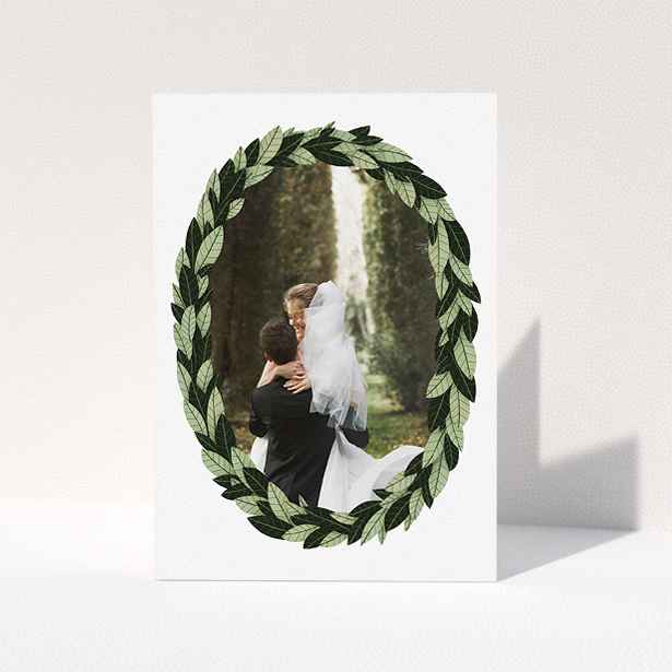 A wedding thank you card design titled "Thick Wreath Frame". It is an A5 card in a portrait orientation. It is a photographic wedding thank you card with room for 1 photo. "Thick Wreath Frame" is available as a folded card, with tones of light green and dark green.