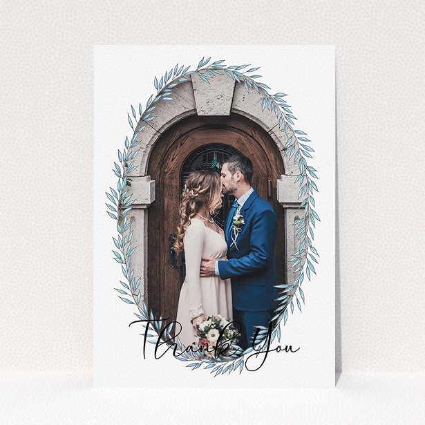 A wedding thank you card design called "Tussled Wreath Frame". It is an A5 card in a portrait orientation. It is a photographic wedding thank you card with room for 1 photo. "Tussled Wreath Frame" is available as a flat card, with mainly blue colouring.