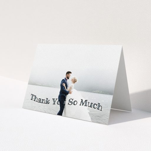 A wedding thank you card design named 'Wave of Thanks'. It is an A6 card in a landscape orientation. It is a photographic wedding thank you card with room for 1 photo. 'Wave of Thanks' is available as a folded card, with mainly blue colouring.