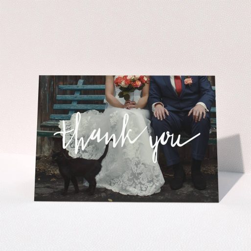 A wedding thank you card template titled "Wonky thank you". It is an A5 card in a landscape orientation. It is a photographic wedding thank you card with room for 1 photo. "Wonky thank you" is available as a folded card, with mainly white colouring.