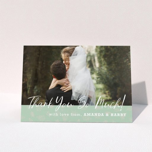 A wedding thank you card design called "Woodland Footer". It is an A5 card in a landscape orientation. It is a photographic wedding thank you card with room for 1 photo. "Woodland Footer" is available as a folded card, with tones of green and white.