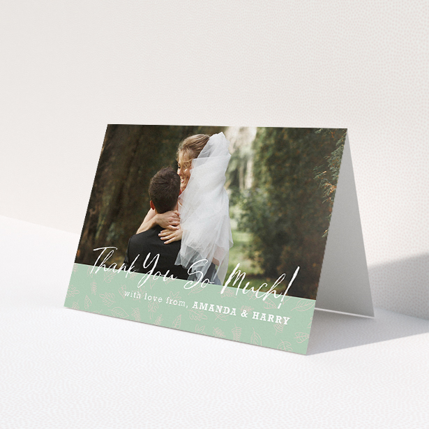 A wedding thank you card design called "Woodland Footer". It is an A5 card in a landscape orientation. It is a photographic wedding thank you card with room for 1 photo. "Woodland Footer" is available as a folded card, with tones of green and white.
