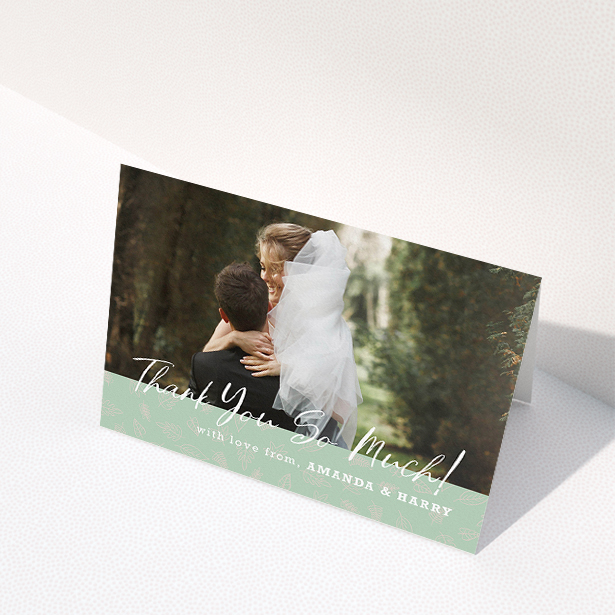 A wedding thank you card design called "Woodland Footer". It is an A5 card in a landscape orientation. It is a photographic wedding thank you card with room for 1 photo. "Woodland Footer" is available as a folded card, with tones of green and white.