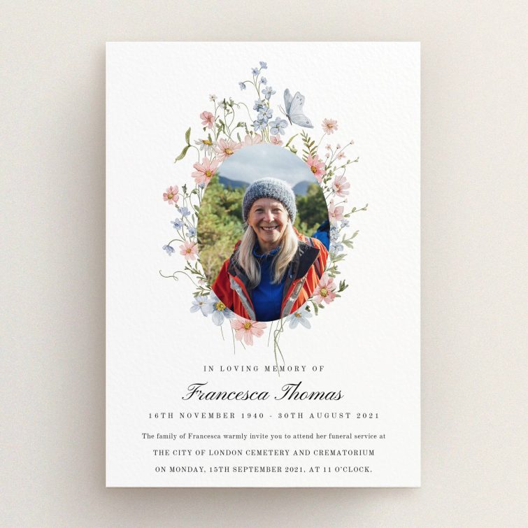 Floral design funeral announcement with one photo of a woman wearing a hat.