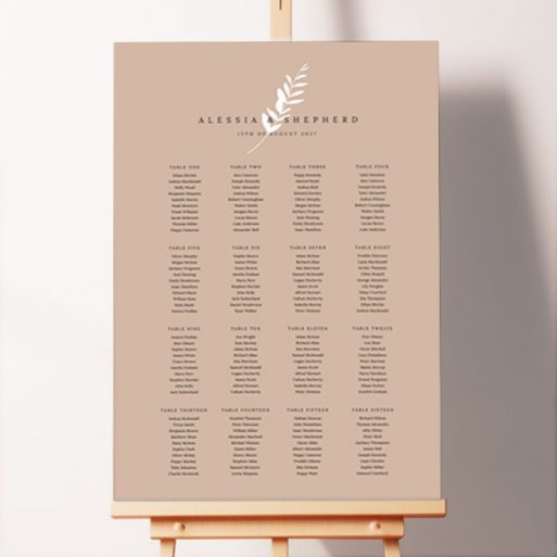 Winter Fern Foamex Seating Plans with a dark cream or taupe background and a white fern at the centre, capturing the serene beauty of winter or autumn for your seasonal wedding.. This template shows 16 tables.