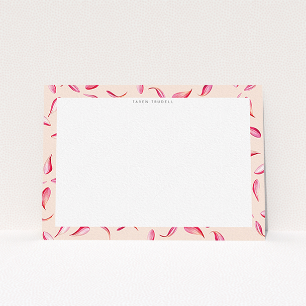 A womens correspondence card design titled "Petal confetti". It is an A6 card in a landscape orientation. "Petal confetti" is available as a flat card, with tones of pink, red and white.